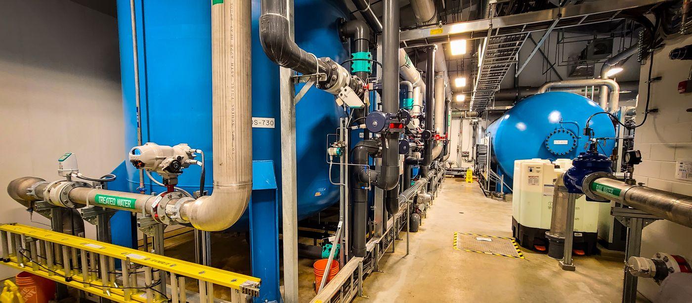 Interior of a municipal water treatment plant, showing filtration vessels, valves, actuators and instrumentation